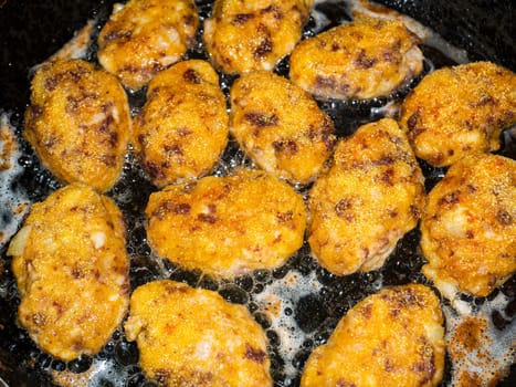 Meat cutlets are fried in a skillet. Food photo. Meat dish. Preparing food. Home kitchen. Recipe. Raw minced meat. Chicken's meat. Cutlets. Cook. Advertising photo of a shop window. Sunflower oil.