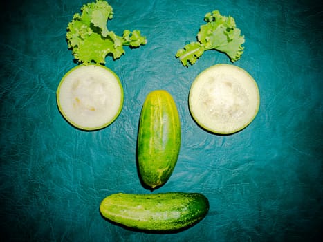 Sliced vegetable cucumber and zucchini on the kitchen table. Food photo. Cooking food. Home kitchen. Cucumber vegetable. Vegetarian food. Showcase advertising photo. Human face. Green salad.