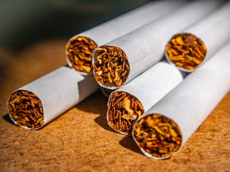 A closeup of cigarette filters in a pack. The tobacco industry. The harm of nicotine. Filtered cigarettes. The cigarette industry. Background image. Place for your text. Health and medicine.
