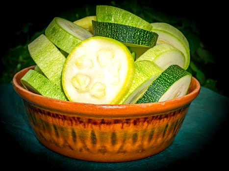 Sliced vegetable marrow in a plate on the kitchen table. Food photo. Cooking food. Home kitchen. Vegetarian food. Advertising photo of a shop window. Poster.