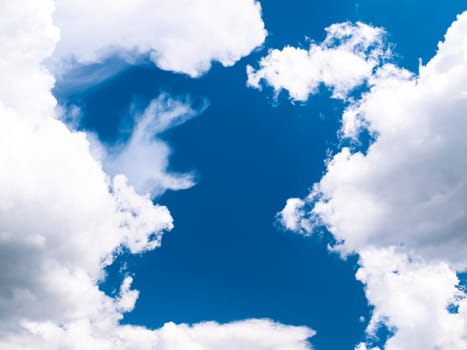 White clouds on a background of blue sky. Cloudy landscape. Cumulus clouds. Outer space. Stratosphere. Background image. Place for text. Template. Poster. sunlight.
