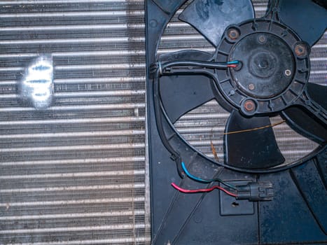 Aluminum radiator for engine cooling with blower fan. Refrigeration system cooling condenser. Refrigerator evaporator. Car repair workshop. Refrigerator repair. Air conditioning system.