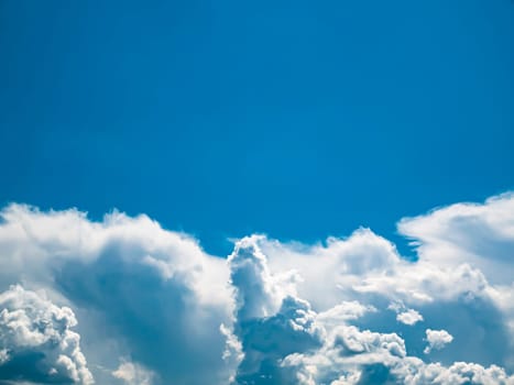 Flying over white clouds against a blue sky. Space. Stratosphere. Cumulus clouds. Background image. Place for your text. Template. Poster. Advertising photo.