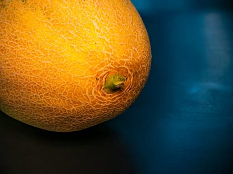 Yellow ripe melon on a black background. Food photo. Melon culture. Agriculture. Place for your text. Black background. Background image. Shchablon. Poster. Vegetarian food.