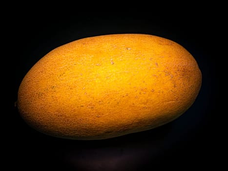 Yellow ripe melon on a black background. Food photo. Melon culture. Agriculture. Place for your text. Black background. Background image. Shchablon. Poster. Vegetarian food.