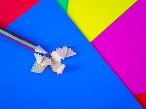 Sharpening a pencil for drawing with a sharpener. School drawing lesson. Eraser. Place for your text. Template. Background image. Poster. Sheets of colored paper.