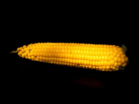 Yellow swing of corn on a black background. Boiled corn. Harvest. Agriculture. Food photo. Black background. Place for your text. Background image. Poster. Vegetarian food.
