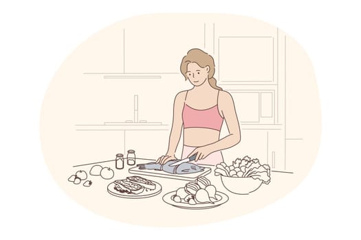 Healthy homemade food, clean eating, diet concept. Young positive woman standing in kitchen and cooking fish with fresh vegetables for dinner at home alone. Wellness, bodycare, healthy lifestyle