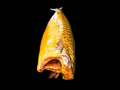 Smoked mackerel fish on a black background. Salted mackerel fish. Canned food. Food photo. Recipe. Menu of dishes. Vegetarian food. Home kitchen. Fishing. Background image. Place for your text.