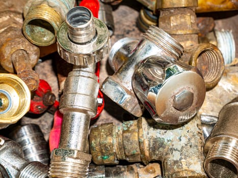 Old taps with a valve for opening water tap. Valve for opening and closing water. Plumbing equipment. Plumbing repair. Plumbing repairman. Pipeline. Background image. Place for your text.