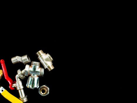 Faucet with a tap on a black background. Valve for opening and closing water. Plumbing equipment. Plumbing repair. Plumbing repairman. Pipeline. Background image. Place for your text.