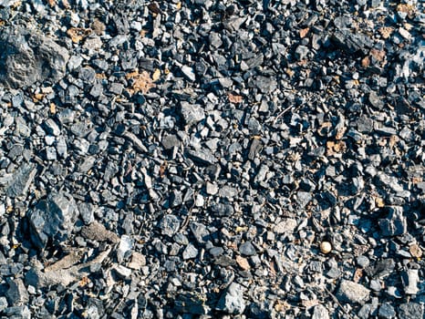 Lumps of black coal on the surface of the earth. Coal mining industry. Underground resources of the earth. Mining. Black background. Ecological catastrophy. Environmental protection.