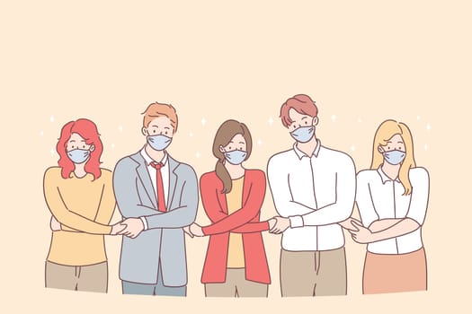 Teamwork, unity, protective masks during coronavirus pandemic concept. Young people business partners or creative colleagues standing and holding hands as symbol of uniting efforts and common goal