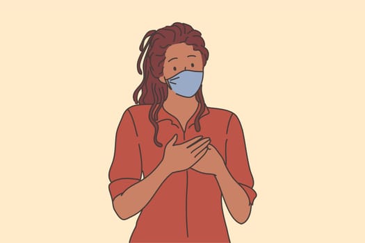 Kindness and support during COVID-19 epidemic concept. Portrait of kind black woman in respiratory mask from coronavirus infection holding hands on chest as symbol of love and care