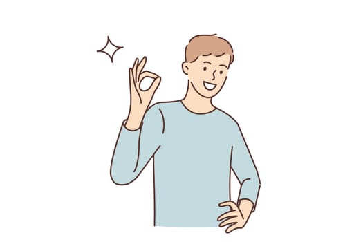 Ok sign and gesture language concept. Young smiling man cartoon character standing showing ok sign with fingers looking at camera vector illustration