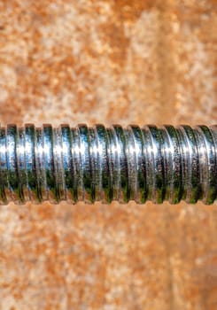 Iron bolt with thread for tightening the nut. Threaded connection of parts with a bolt and a nut. Parts fastening technology. Locksmith accessories. Background image. Place for your text.