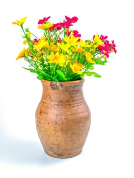 A bouquet of artificial flowers in a clay jug. Bouquet of pink and yellow flowers. Ceramic vase. Earthenware. Handmade. White background. Background image. Place for your text.