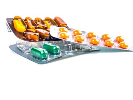 Medical medicine in pills on a white background. Pharmacy drugs in tablets. Pharmacology. Medical medicine in capsules. Pharmacy capsules for human treatment. Place for your text. Drugs in pills.