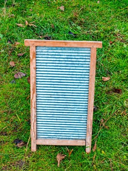 Retro household board for hand washing clothes. Board for hand washing clothes. Housekeeper. Laundry soap. Soapy water. Wooden frame. Washer. Place for your text. Womens homework.