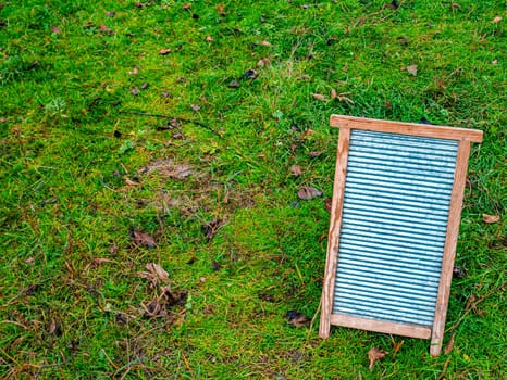 Retro household board for hand washing clothes. Board for hand washing clothes. Housekeeper. Laundry soap. Soapy water. Wooden frame. Washer. Place for your text. Womens homework.