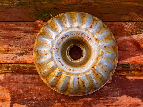 Aluminum bakeware for baking in the oven. Aluminum baking dish made of flour dough. Wooden kitchen table. Home kitchen. Bakers tool. Cook equipment. Cooking utensils. Cooking a flour dish.