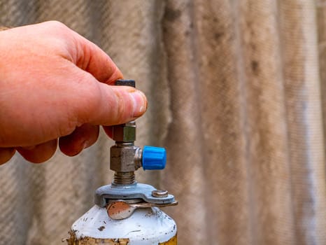 Freon cylinder needle valve for refrigerator repair. Needle valve for gas cylinder. Filling the refrigerator with freon. Filling the air conditioner with freon. Air conditioner repair. Work tool.