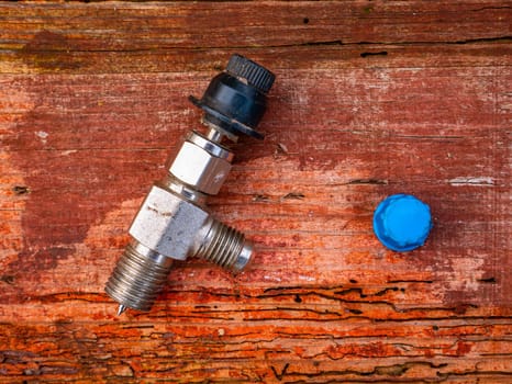 Freon cylinder needle valve for refrigerator repair. Needle valve for gas cylinder. Filling the refrigerator with freon. Filling the air conditioner with freon. Air conditioner repair. Work tool.