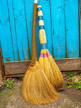 Wicker broom made of sorghum for indoor sweeping. Broom for sweeping the floor. House cleaning. Cleaning of office premises. Cleanliness and tidiness. Cleaning of the territory. Tool.