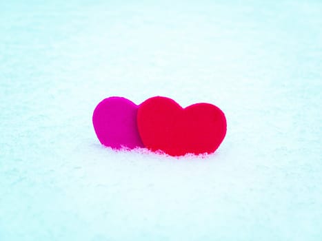 Valentine red heart symbol on white snow. Valentine's Day. Red valentine. Heart symbol. Day of Love. Feast in February. Valentine's day holiday. Fate. Engagement. Wedding. Greeting card.