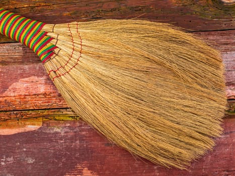 Wicker broom made of sorghum for indoor sweeping. Broom for sweeping the floor. House cleaning. Cleaning of office premises. Cleanliness and tidiness. Cleaning of the territory. Tool.
