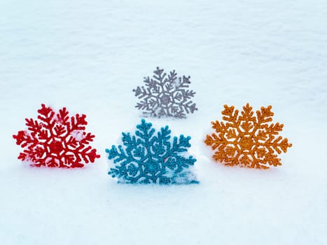 Christmas tree toys colored snowflakes on white snow. Christmas holidays. New Year. Loose winter snow. New Years holidays. Winter vacation. Place for text. Greeting card. White background.