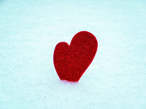 Valentine red heart symbol on white snow. Valentine's Day. Red valentine. Heart symbol. Day of Love. Feast in February. Valentine's day holiday. Fate. Engagement. Wedding. Greeting card.