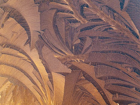 The texture of patterns of frost on the glass in winter. Frosty pattern on a glass window. White snow. Frozen water. Crystals of ice. Winter season. Weather. Weather forecast. Background image.