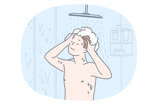 Taking shower and personal hygiene concept. Young smiling boy enjoying shampoo and hot water during taking shower in bathroom. Routine casual things for individual bodycare