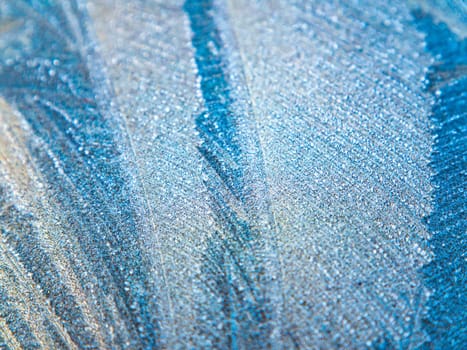 The texture of patterns of frost on the glass in winter. Frosty pattern on a glass window. White snow. Frozen water. Crystals of ice. Winter season. Weather. Weather forecast. Background image.