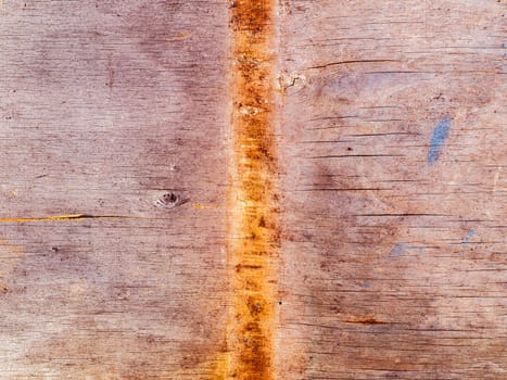 Faded texture of a wooden plank surface with rusty spots. Rusty metal stains on a wooden board. Bough of a tree. Aging process. Background image. Place for text. Cracks. Poster.