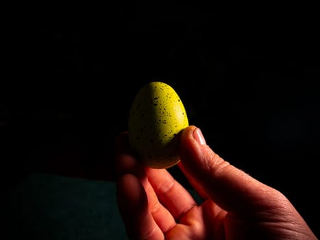Easter chicken eggs in hand on a black background. Easter chicken eggs. Christ is risen. Christian religion. Religious holiday. Palms of human hands. Christian culture. Religious prayer. Tradition.