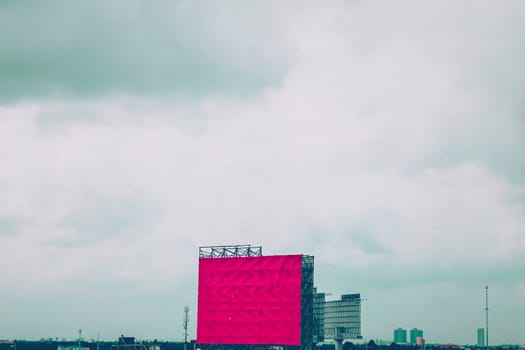 Blank billboard for new advertisement. Mockup Large red blank billboard or white promotion poster displayed on the outdoor against the blue sky background. Promotion information for marketing announcements and details