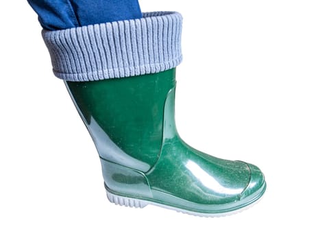 The leg of a man in a green rubber boot on a white background. Human leg. Rubber boot. Rain shoes. Shoes for dirt. White background. Shop window. Shoe sole. Shoe size.