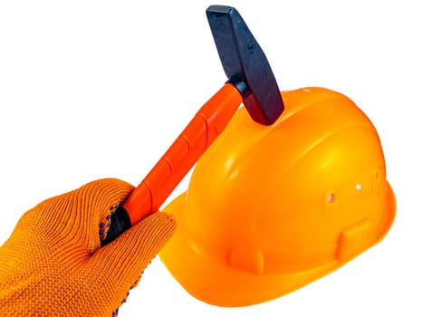 Orange protective construction helmet and iron hammer. Iron hammer. Worker's orange safety helmet. Construction and repair. Work tool. Protective equipment at work. White background.