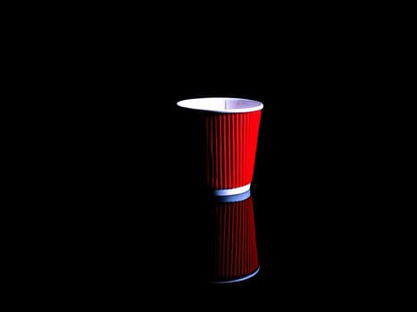 Disposable cardboard cups for coffee on a black background. Cardboard glass. Disposable tableware. Coffee drinks. Red color. Paper dishes for drinks. Black background. Darkness.