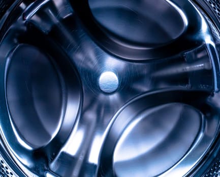Metal drum of the washing machine made of stainless steel. Stainless steel tank. Washing machine repair service. Household appliances repair workshop. Mechanic repairman. Home wash.
