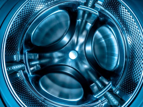 Metal drum of the washing machine made of stainless steel. Stainless steel tank. Washing machine repair service. Household appliances repair workshop. Mechanic repairman. Home wash.