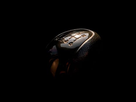 Car manual transmission shift knob on a black background. Manual transmission of the car. Vehicle driving. The profession is a vehicle driver. Digital numbering. Shift lever. Black background.