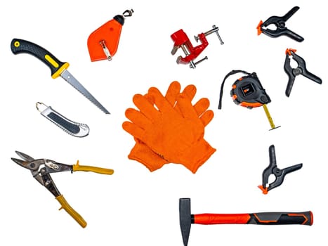 Orange gloves of a worker and a construction tool on a white background. Worker mittens. Construction tool. Renovation of apartments. Renovation in the house. Equipment set.