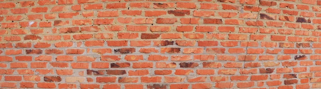 Texture of a red brick wall with cement joints. Old brick. Brickwork. Cement mortar. Construction and repair. Retro style. Weathered surface. Background image. Template for text. Business.