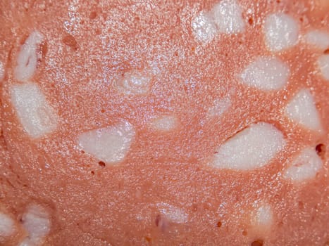 The texture of meat sausage with lard. Pork sausage. Fatty food. Lard. Home kitchen. Ingredient for the sandwich. High-calorie food. Background image.