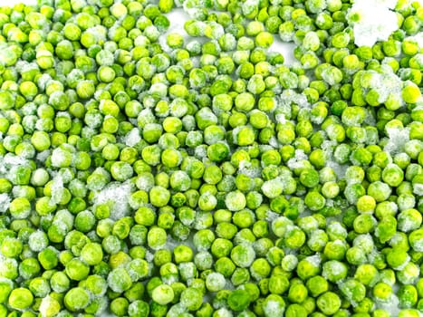 Frozen green peas vegetable on a white plate. Frozen vegetables. Green peas. Food in the refrigerator. Food storage. Vegetarian food. Harvest storage. White background.