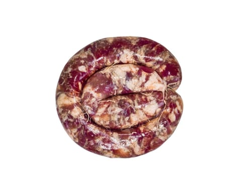 Ring of homemade meat sausage on a white plate. Pork meat. Raw pork sausage. Pig intestine. Greasy sausages. High-calorie food. Not vegetarian food. Menu of dishes. Home kitchen.