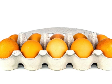 Brown chicken eggs in a carton box. Egg. Paper containers. Healthy food. Poultry products. Chicken egg shells. Packaged food. Agricultural business. Eco food. White background.